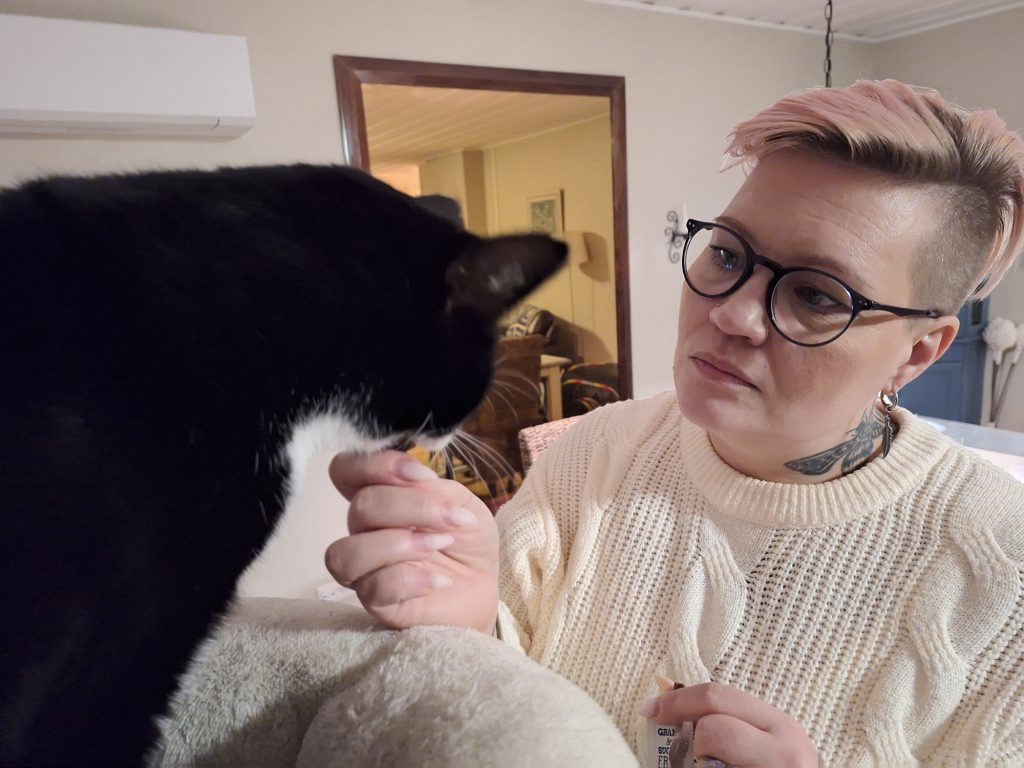 Wallu Waldemar Valkovarvas ja Salon eläinsuojeluyhdistyksen kissapuolen aktiivi Johanna Råman vaihtavat kuulumisia kiipeilypuun luona.